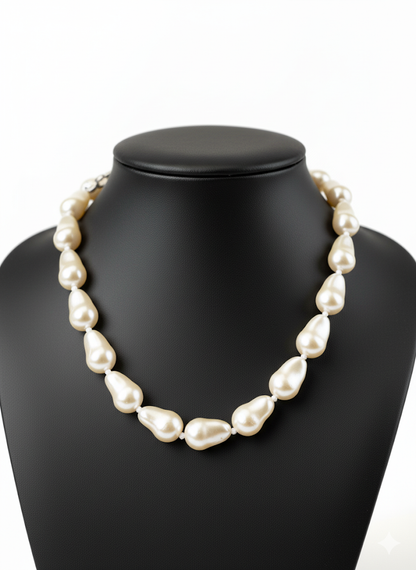 Pearl necklace on a black mannequin bust with a white background