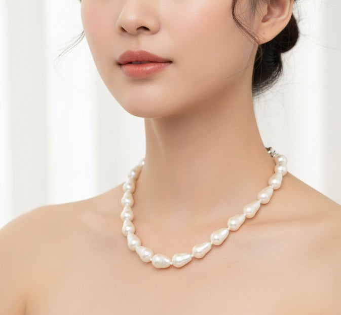 Pearl necklace worn by a model on a white background
